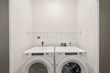 Two white washing machines